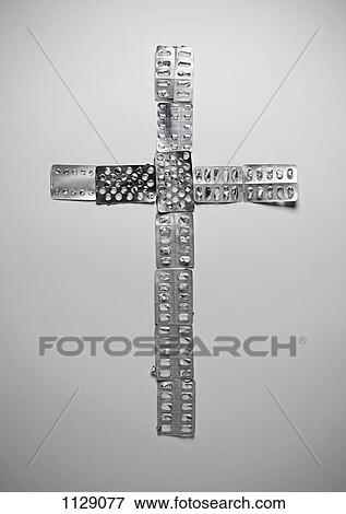 Empty packaging for medication arranged in a cross shape View Large Photo Image Stock Photo - Empty packaging for medication arranged in a cross shape. Fotosearch
