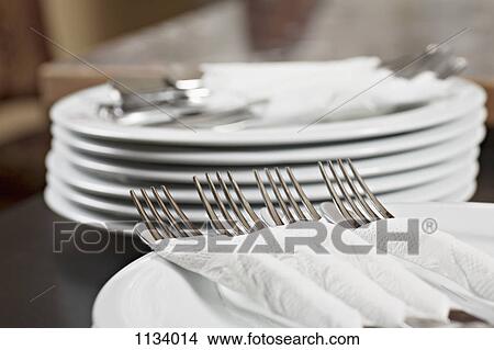 Forks and knives wrapped in paper napkins View Large Photo Image Picture - Forks and knives wrapped in paper napkins. Fotosearch