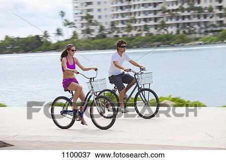 Girl and boy cycling on promenade View Large Photo Image Stock Photo - Girl and boy cycling on promenade. Fotosearch