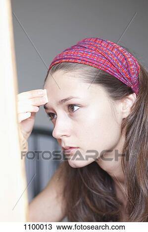 Stock Image - Girl applying face foundation. Fotosearch