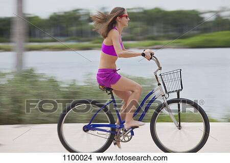 Girl cycling barefoot View Large Photo Image Picture - Girl cycling barefoot. Fotosearch