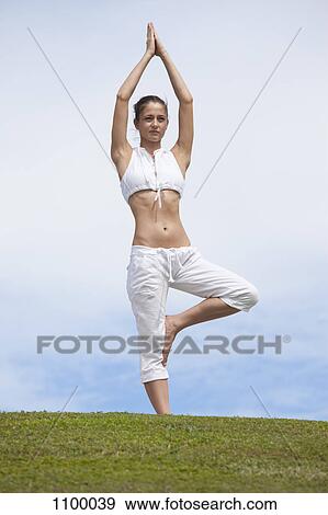 Girl does yoga (Tree Pose) on hill View Large Photo Image Stock Photo - Girl does yoga (Tree Pose) on hill. Fotosearch