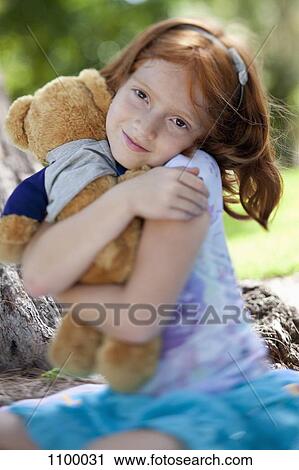 Girl hugging teddy bear View Large Photo Image Stock Image - Girl hugging teddy bear. Fotosearch