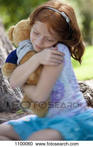 Girl hugging teddy bear View Large Photo Image Stock Image - Girl hugging teddy bear. Fotosearch