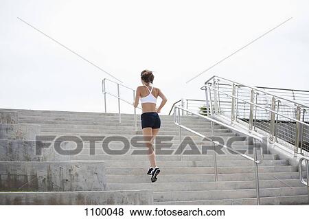 Stock Photo - Girl jogging up steps. Fotosearch