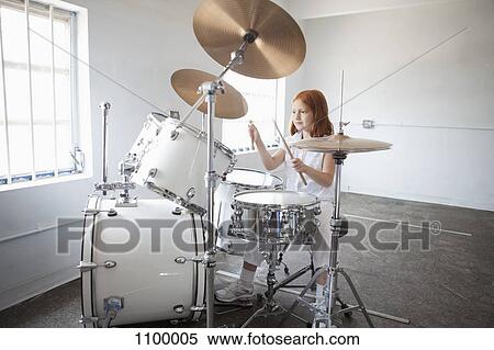 Stock Photography - Girl plays drum kit. Fotosearch