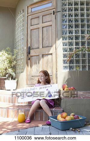 Girl selling apples on front porch and holding sign View Large Photo Image Stock Photograph - Girl selling apples on front porch and holding sign. Fotosearch