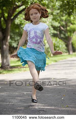 Girl skipping through park View Large Photo Image Stock Photography - Girl skipping through park. Fotosearch