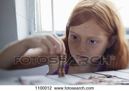 Girl stacking coins View Large Photo Image Stock Image - Girl stacking coins. Fotosearch