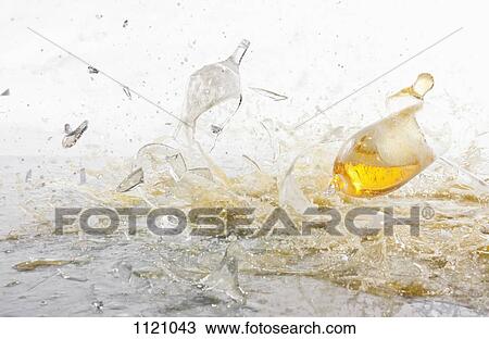 Stock Image - Glasses of beer shattering. Fotosearch