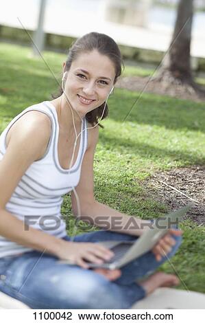 Happy girl using laptop outside View Large Photo Image Stock Image - Happy girl using laptop outside. Fotosearch
