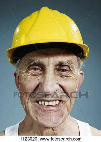 Headshot of a senior man wearing a yellow hardhat View Large Photo Image Stock Image - Headshot of a senior man wearing a yellow hardhat. Fotosearch