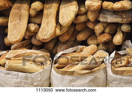 Stock Image - Heaps of fresh baked loafs of bread. Fotosearch
