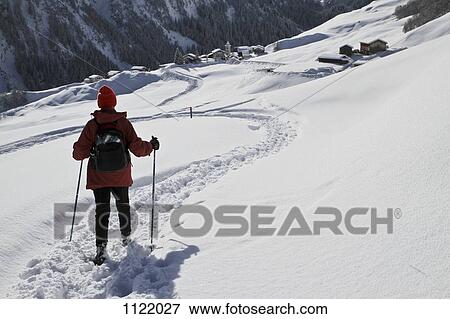 Hiker on the way to snowy village View Large Photo Image Stock Photo - Hiker on the way to snowy village. Fotosearch