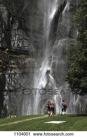 Hikers walking towards a waterfall, Chiavenna, Lombardy, Italy View Large Photo Image Stock Image - Hikers walking towards a waterfall, Chiavenna, Lombardy, Italy. Fotosearch