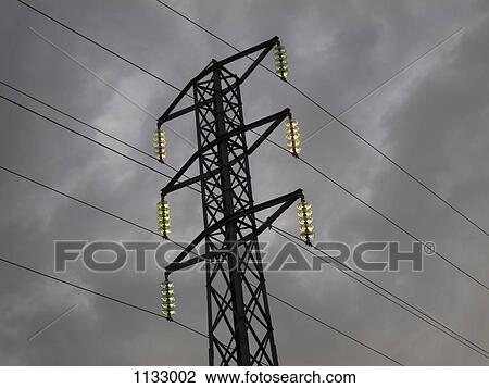 Stock Image - Illuminated lights on an electricity pylon. Fotosearch