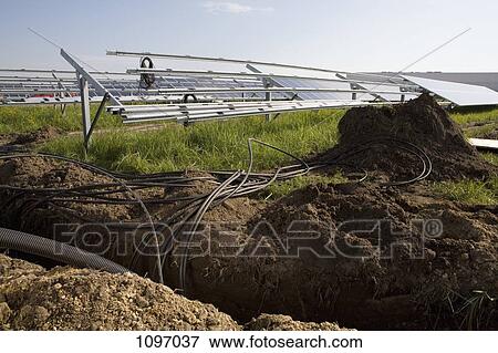 Installation of pipes and solar panels in a field View Large Photo Image Stock Photo - Installation of pipes and solar panels in a field. Fotosearch
