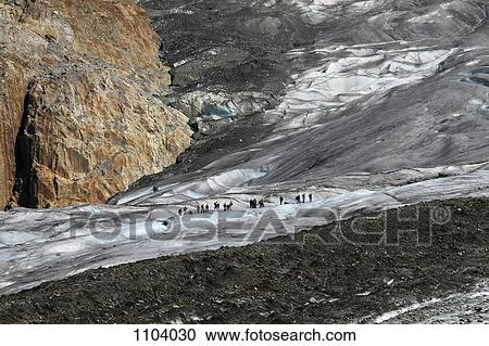 Large group of hikers in the distance, Aletsch Glacier, Valais Canton, Switzerland View Large Photo Image Stock Image - Large group of hikers in the distance, Aletsch Glacier, Valais Canton, Switzerland. Fotosearch