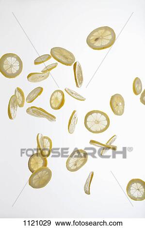 Lemon slices against a white background View Large Photo Image Stock Photo - Lemon slices against a white background. Fotosearch