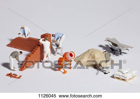 Miniature bricklayers building a brick wall View Large Photo Image Stock Photography - Miniature bricklayers building a brick wall. Fotosearch