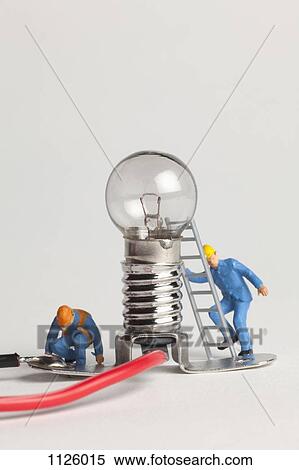 Miniature electrician figurines working on a light bulb View Large Photo Image Stock Photography - Miniature electrician figurines working on a light bulb. Fotosearch