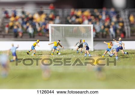 Miniature figurines of two soccer teams playing a soccer match View Large Photo Image Picture - Miniature figurines of two soccer teams playing a soccer match. Fotosearch