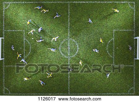 Stock Photo - Miniature figurines of two soccer teams playing a soccer match, directly above. Fotosearch