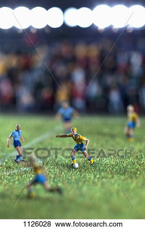Miniature figurines of two soccer teams playing a soccer match View Large Photo Image Stock Photo - Miniature figurines of two soccer teams playing a soccer match. Fotosearch