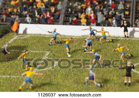Stock Photo - Miniature figurines of two soccer teams playing a soccer match. Fotosearch