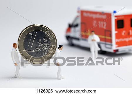 Miniature paramedic figurines carrying a euro coin on a stretcher to a toy ambulance View Large Photo Image Stock Photograph - Miniature paramedic figurines carrying a euro coin on a stretcher to a toy ambulance. Fotosearch