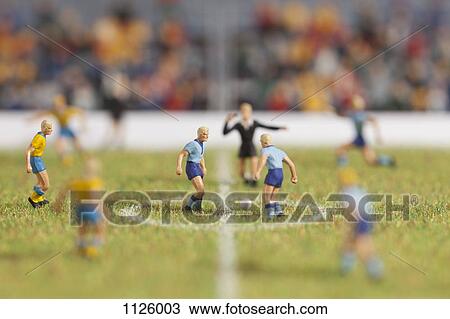 Miniature soccer player figurines at the kick-off of a soccer match View Large Photo Image Stock Image - Miniature soccer player figurines at the kick-off of a soccer match. Fotosearch