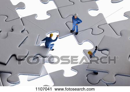Miniature workmen working on assembling a jigsaw puzzle View Large Photo Image Stock Image - Miniature workmen working on assembling a jigsaw puzzle. Fotosearch