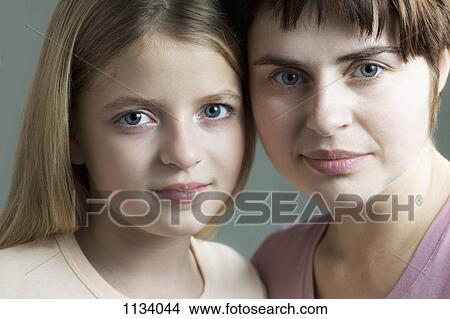 Picture - Mother and daughter cheek to cheek. Fotosearch