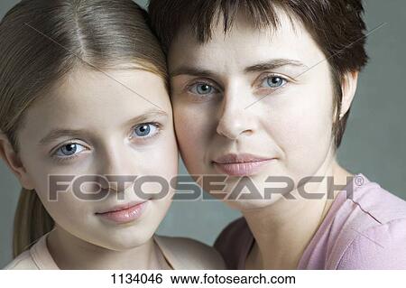 Stock Photograph - Mother and daughter cheek to cheek. Fotosearch