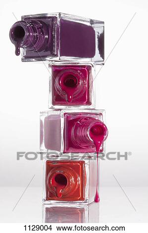 Picture - Nail polish dripping from a stack of bottles. Fotosearch