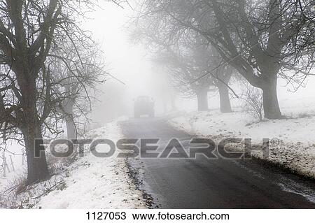 On Winter road with tractor in distance View Large Photo Image Stock Image - On Winter road with tractor in distance. Fotosearch