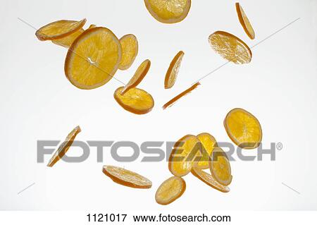 Orange slices against a white background View Large Photo Image Stock Photo - Orange slices against a white background. Fotosearch