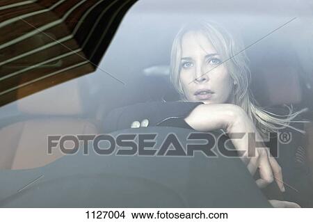 Picture - Pensive woman driving. Fotosearch