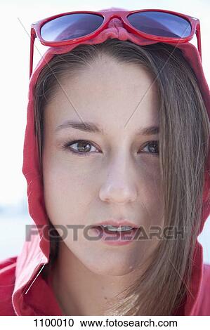 Stock Image - Portrait of girl in red hooded shirt. Fotosearch