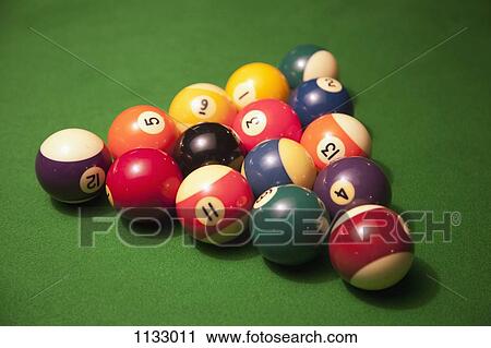 Racked pool balls on a green felt pool table View Large Photo Image Stock Image - Racked pool balls on a green felt pool table. Fotosearch