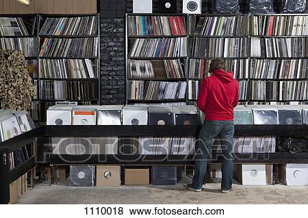 Rear view of young man in a record store View Large Photo Image Stock Photo - Rear view of young man in a record store. Fotosearch