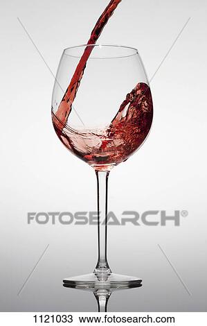 Red wine being poured into a glass View Large Photo Image Stock Image - Red wine being poured into a glass. Fotosearch