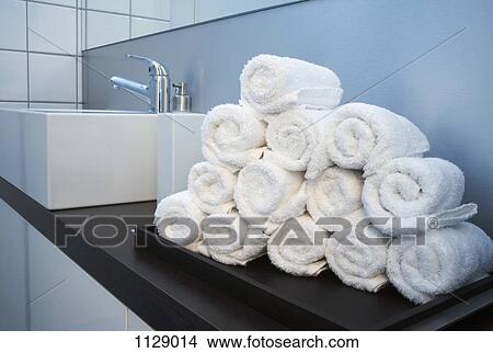Rolled towels stacked in the shape of a pyramid View Large Photo Image Picture - Rolled towels stacked in the shape of a pyramid. Fotosearch