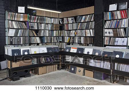Stock Image - Rows of records on shelves and in bins at a record store. Fotosearch