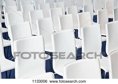 Rows of white chairs, close-up View Large Photo Image Stock Photograph - Rows of white chairs, close-up. Fotosearch