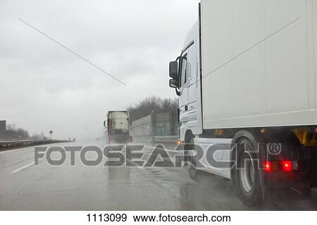 Semi-trucks on a multiple lane highway View Large Photo Image Stock Photo - Semi-trucks on a multiple lane highway. Fotosearch