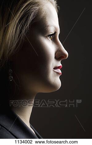 Stock Image - Shadowed profile of young woman. Fotosearch