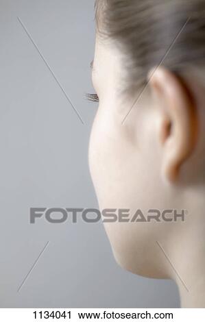 Side of young woman's face View Large Photo Image Stock Image - Side of young woman's face. Fotosearch