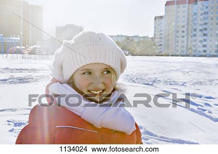 Smiling girl in winter clothes in snowy city park View Large Photo Image Picture - Smiling girl in winter clothes in snowy city park. Fotosearch