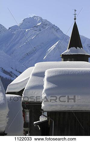 Snow-capped cabins and mountain range in background View Large Photo Image Stock Image - Snow-capped cabins and mountain range in background. Fotosearch